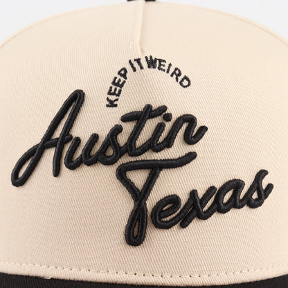 Close-up of the black Austin embroidery on the beige crown