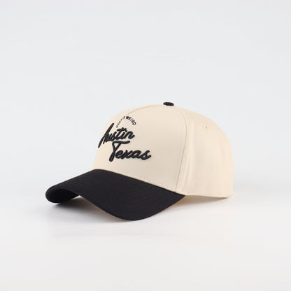 Opposite angled view of the Destination Hat Co. Austin script cap showing the black lettering
