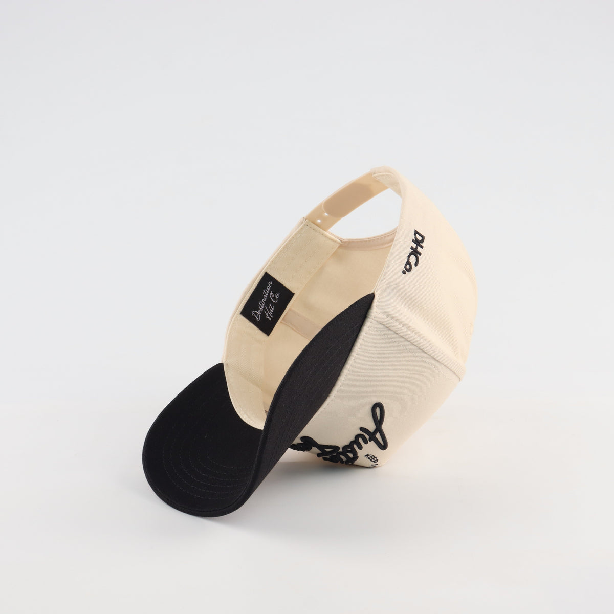 Interior view of the Destination Hat Co. Austin script cap showing the inner band and underside of the bill