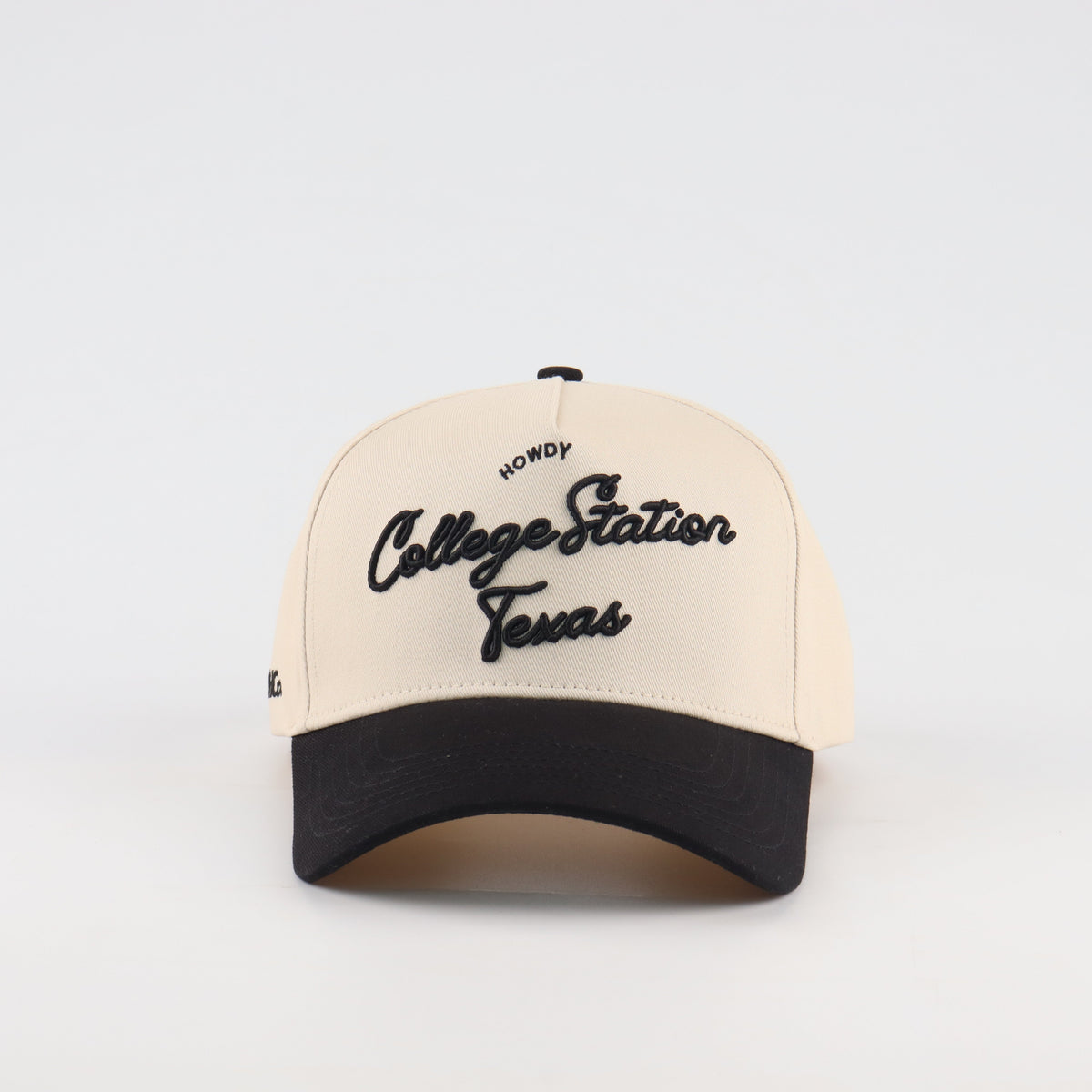 Front view of the Destination Hat Co. College Station script cap with black embroidery