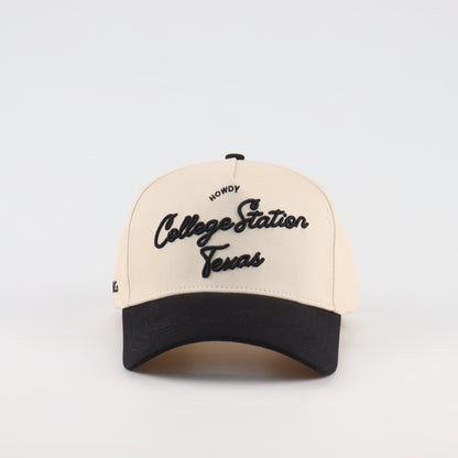 Front view of the Destination Hat Co. College Station script cap with black embroidery