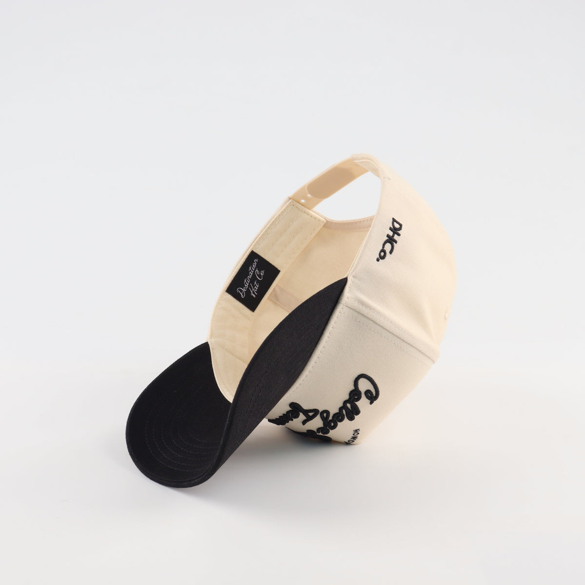 Interior view of the Destination Hat Co. College Station script cap showing the inner band and underside of the bill