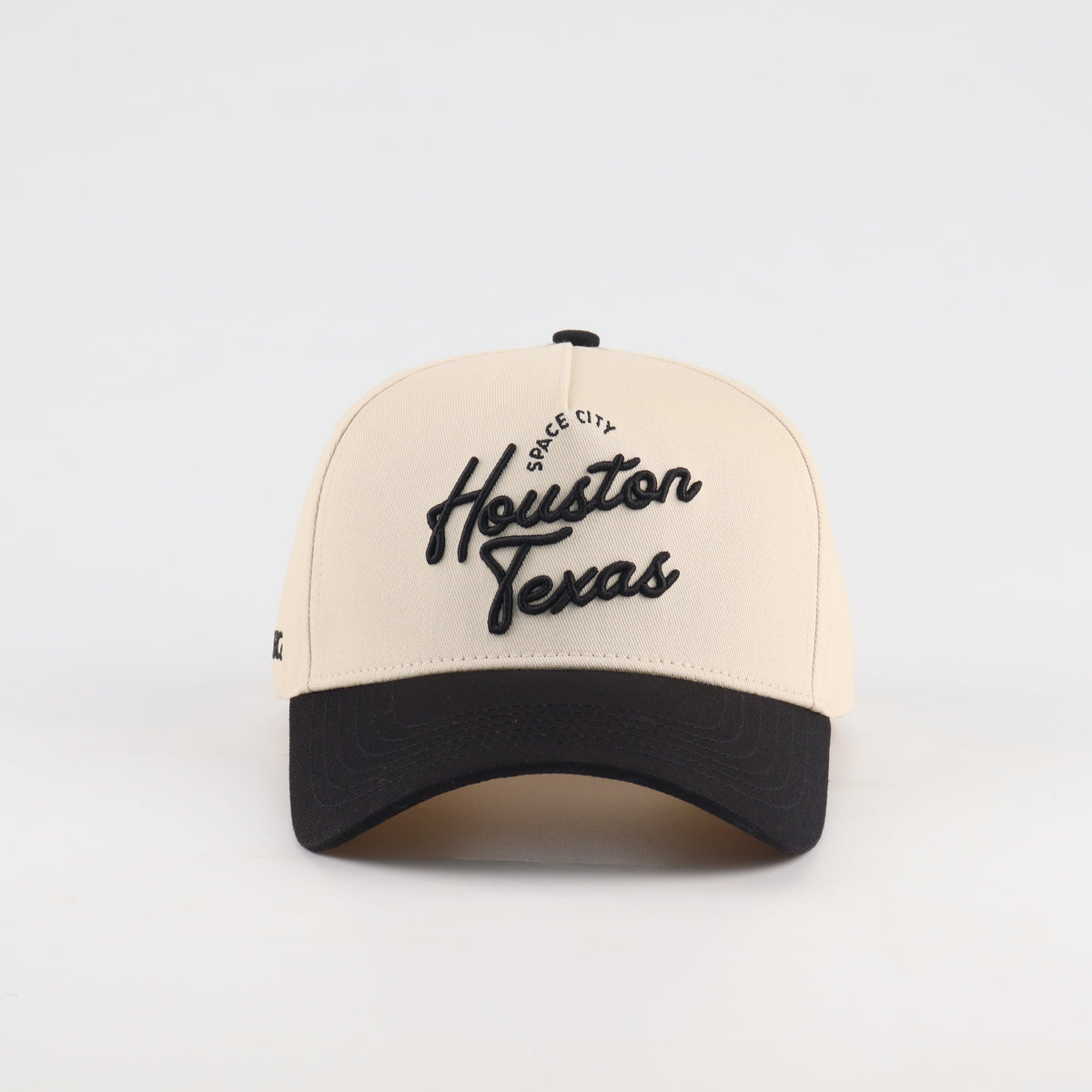 Front view of the Destination Hat Co. Houston script cap with black embroidery