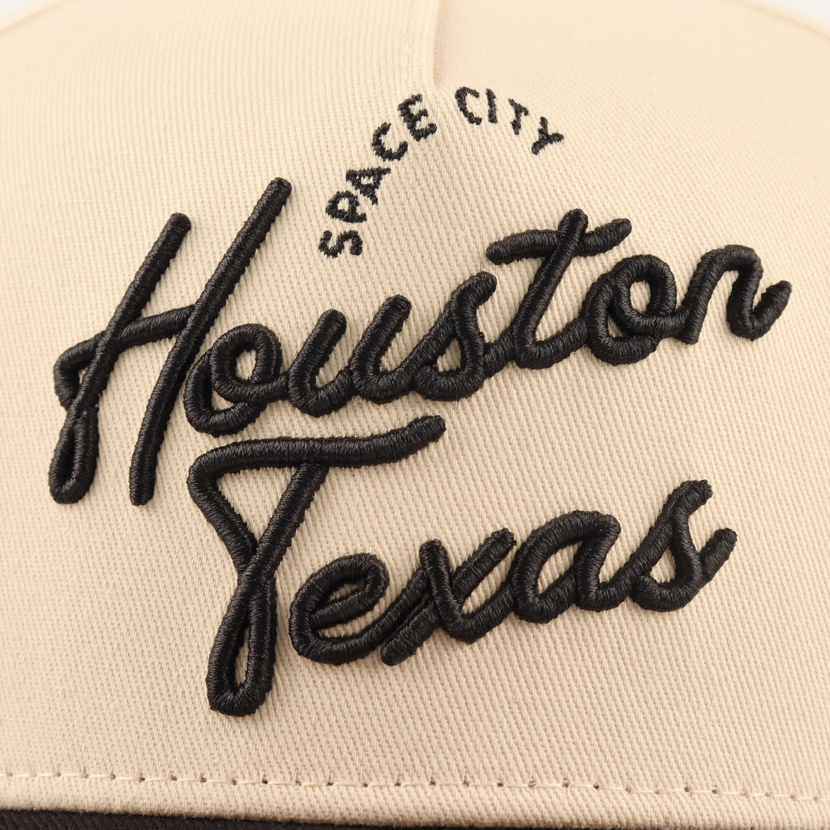 Close-up of the black Houston embroidery on the beige crown