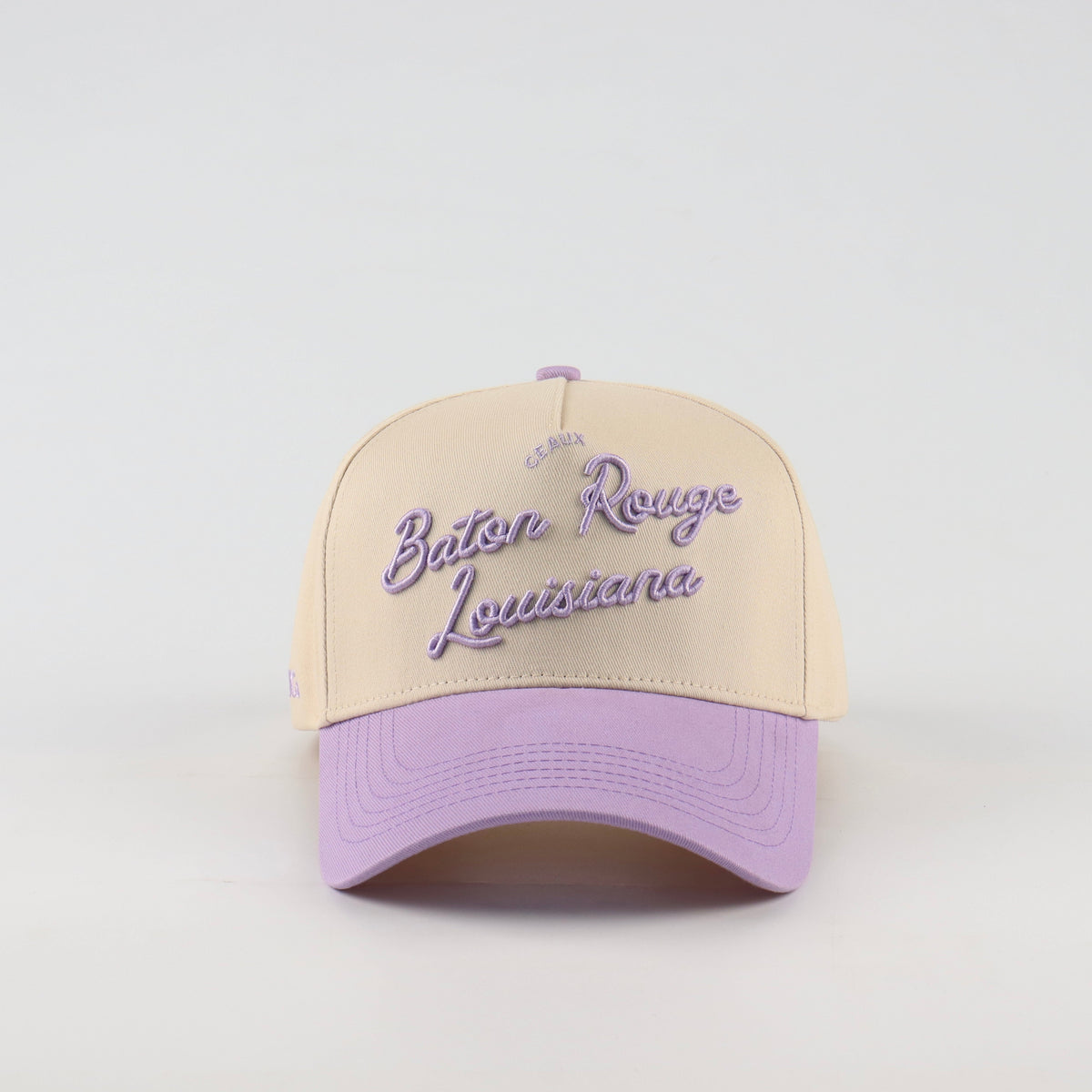Front view of the Destination Hat Co. Baton Rouge script cap with purple embroidery