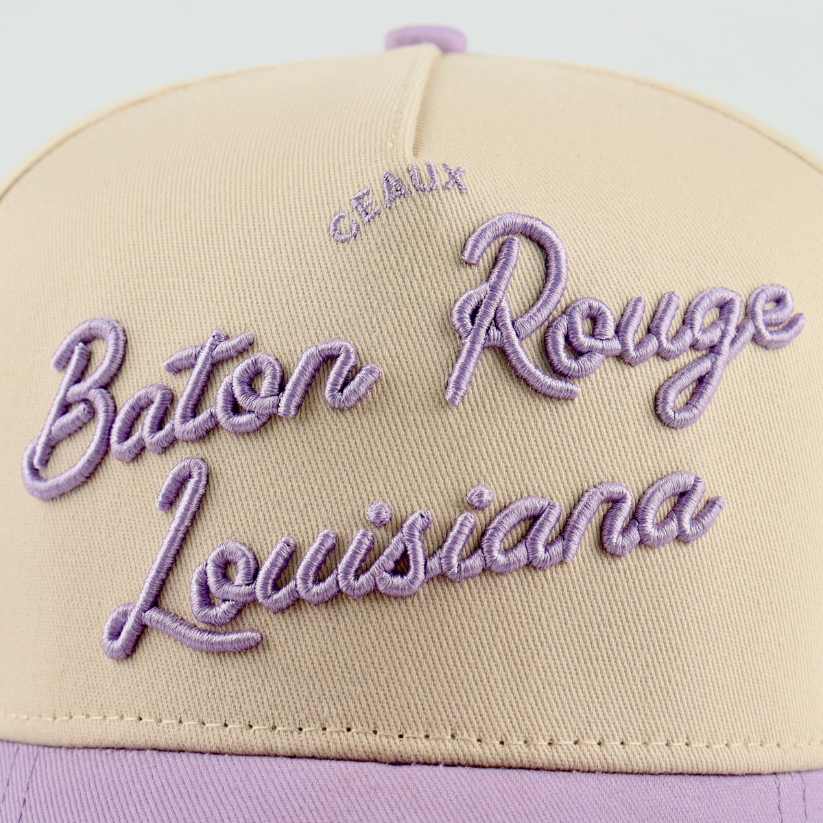 Close-up of the purple Baton Rouge embroidery on the beige crown