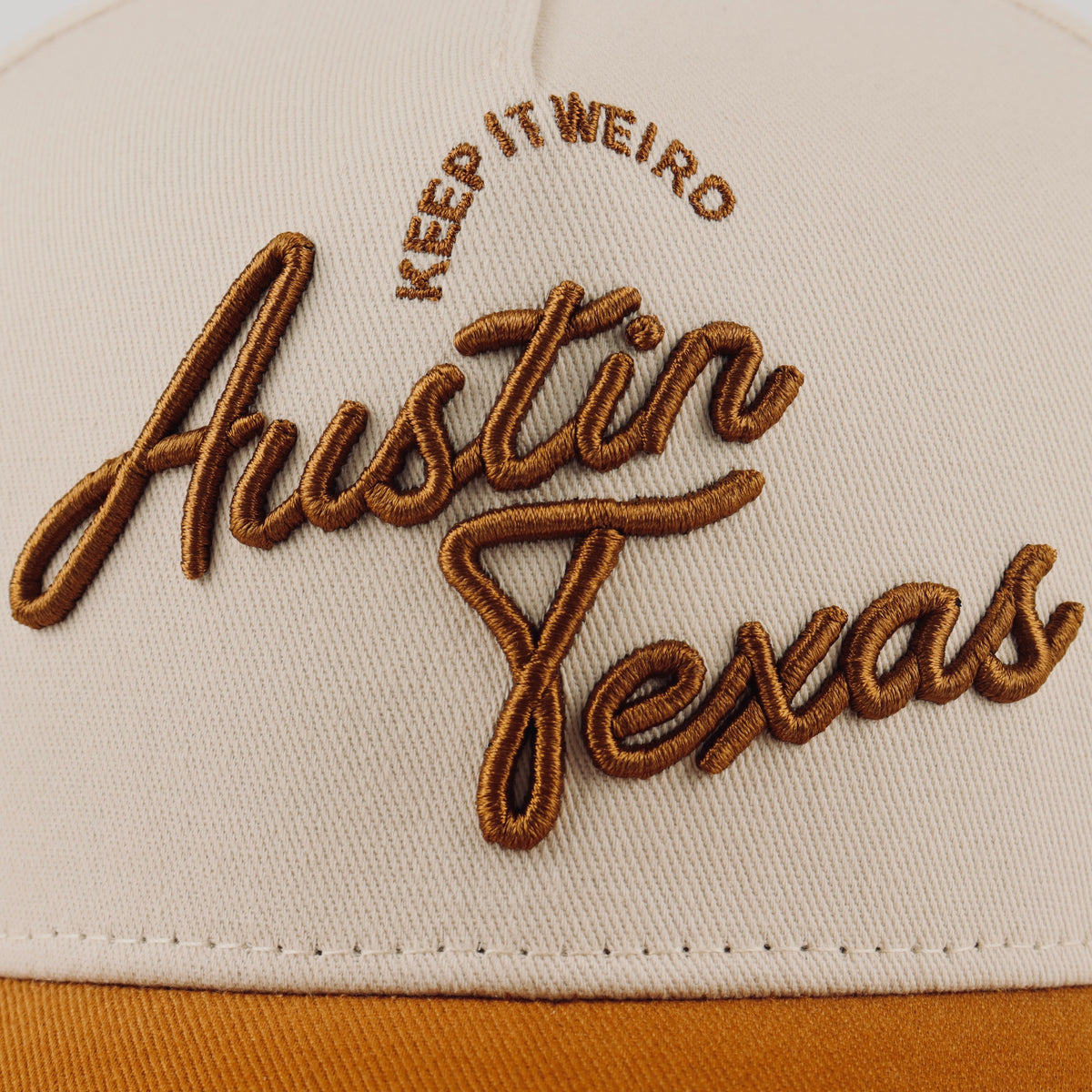 Close-up of the brown Austin embroidery on the beige crown