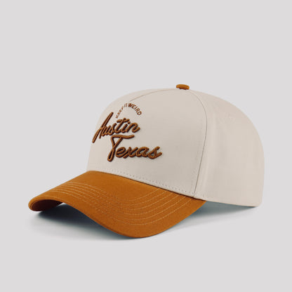 Opposite angled view of the Destination Hat Co. Austin script cap showing the brown lettering