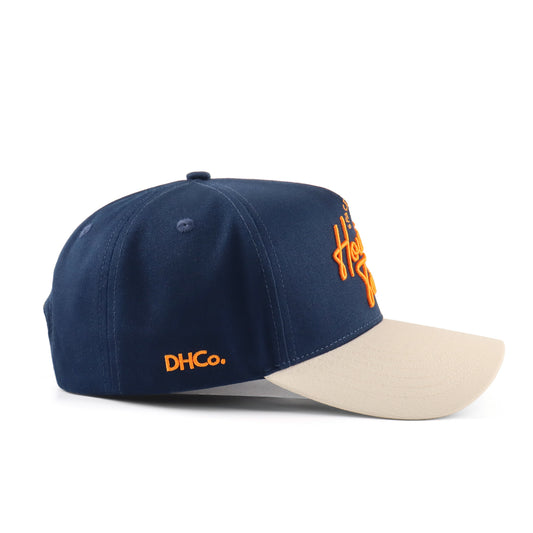Side profile of the Destination Hat Co. Houston script cap showing the curved bill and side logo