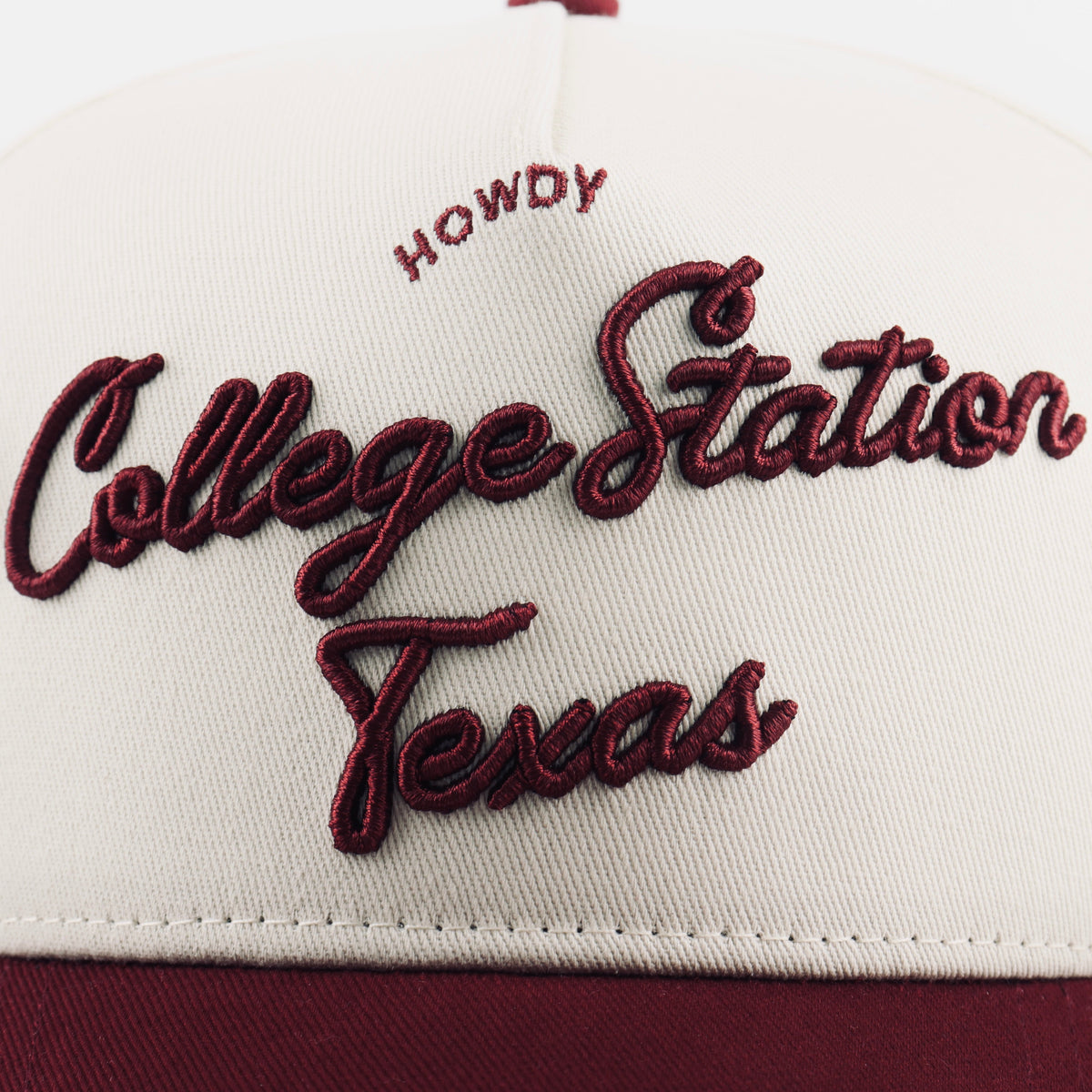 Close-up of raised College Station Texas lettering on the beige crown