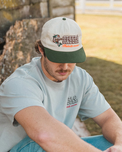 Close outdoor view of the Nashville Sessions cap on a seated model