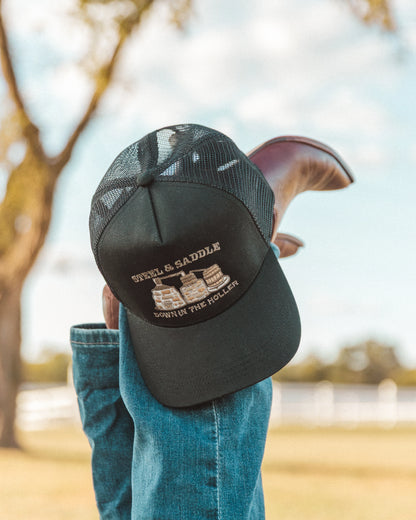 Steel & Saddle Stillhouse Hat resting on a wooden fence post