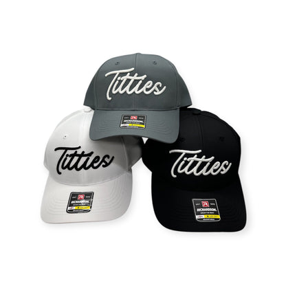 Stacked white, charcoal, and black caps showing contrasting script embroidery