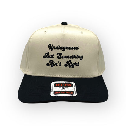 Natural and black Something Ain't Right cap, front view