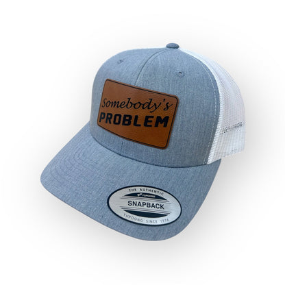 Angled view of the Somebody's PROBLEM patch hat in the Horizon Hat Co. two-hat bundle