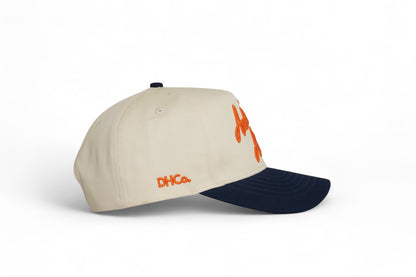 Side profile of the Destination Hat Co. Auburn script cap showing the curved bill and side logo