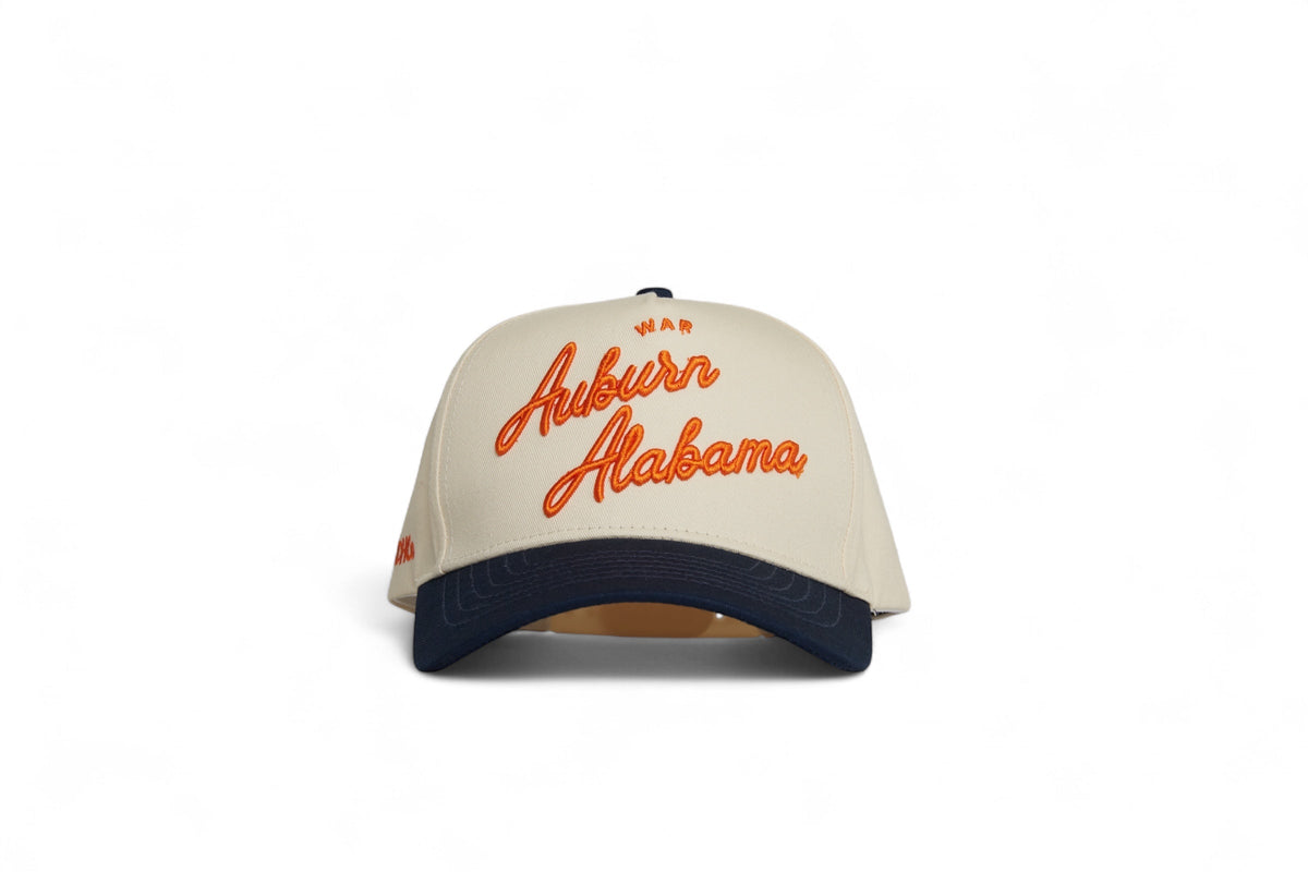 Front view of the Destination Hat Co. Auburn script cap with orange embroidery