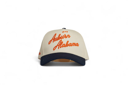 Front view of the Destination Hat Co. Auburn script cap with orange embroidery