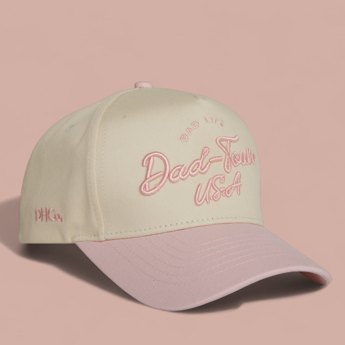Destination Hat Co. Dad-Town script cap with beige crown and light pink bill, angled view