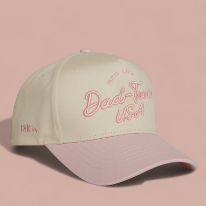 Destination Hat Co. Dad-Town script cap with beige crown and light pink bill, angled view