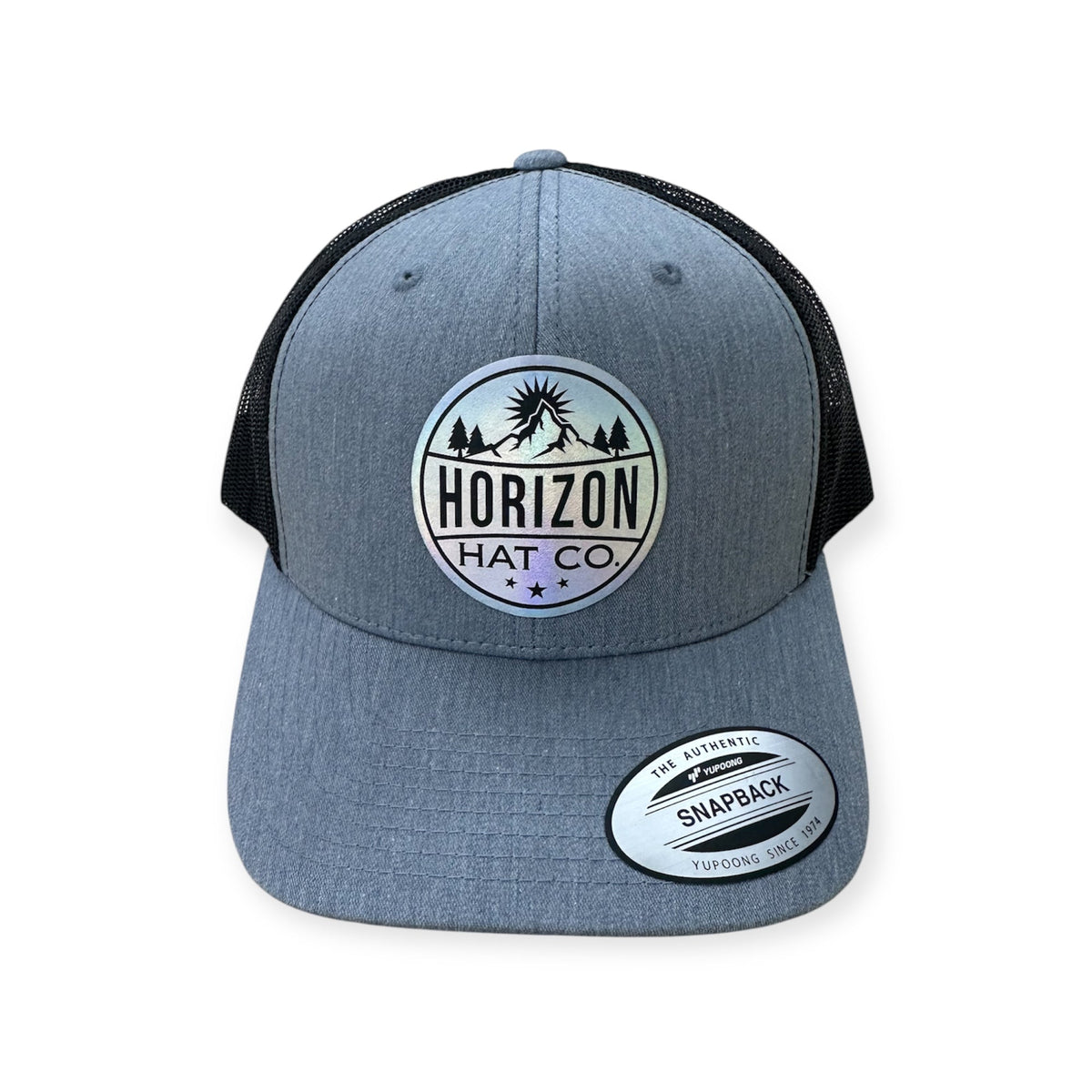 Heather gray and black Horizon trucker with a holographic logo patch