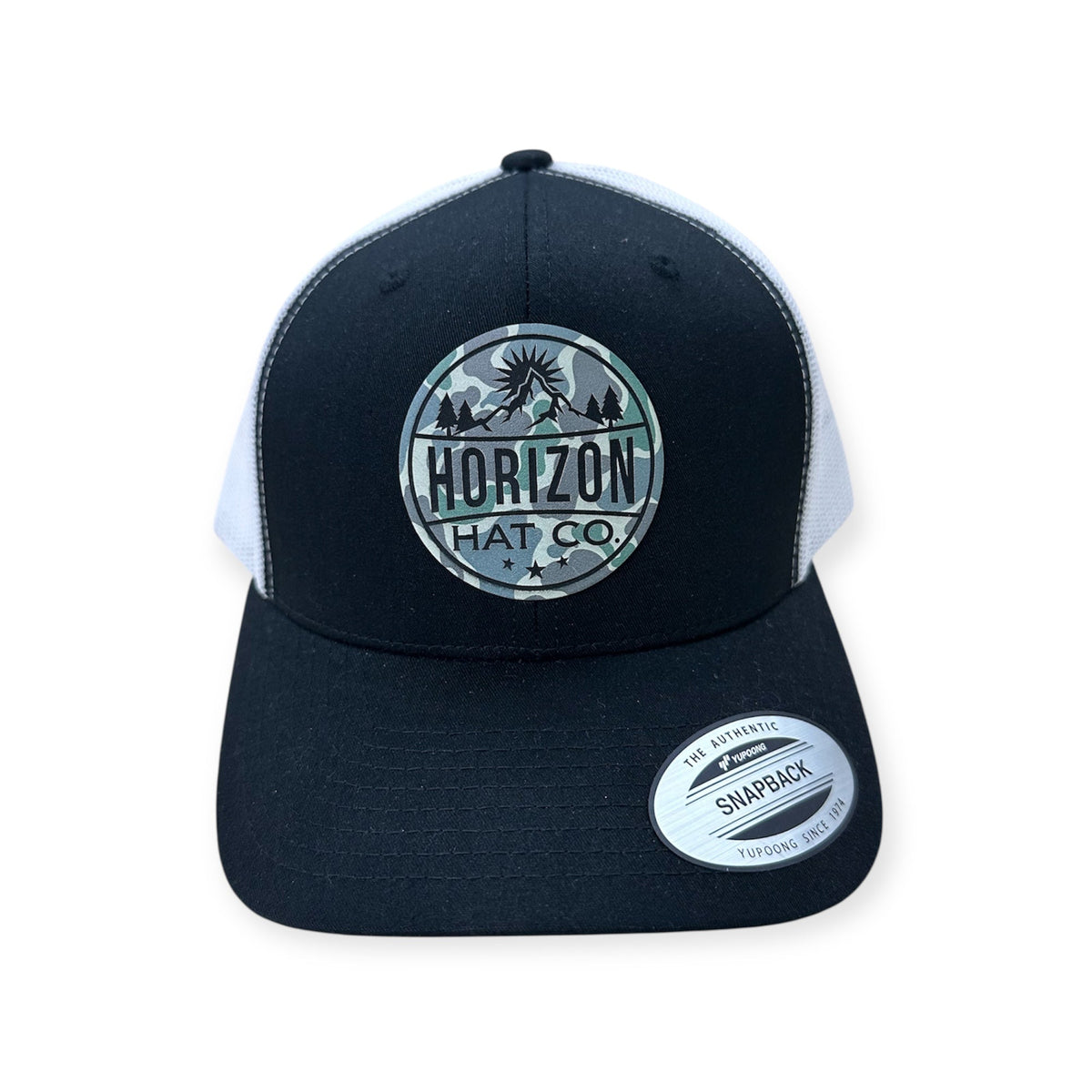Black and white Horizon trucker with a Low Tide logo patch