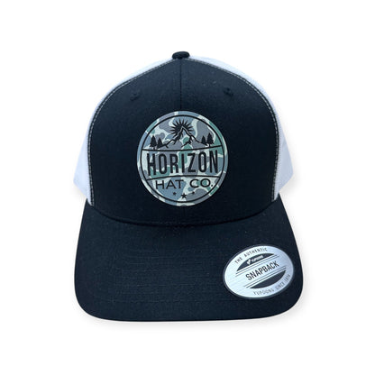 Black and white Horizon trucker with a Low Tide logo patch