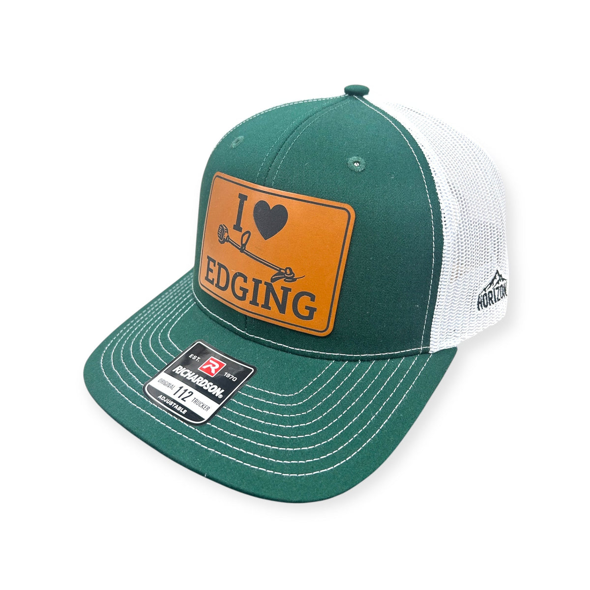 Angled view of I Love Edging patch hat by Horizon Hat Co. in dark green/white showing the bill and side panels