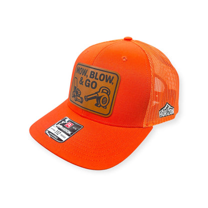 Angled view of Mow, Blow, & Go patch hat by Horizon Hat Co. in orange showing the bill and side panels