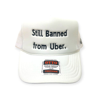Front view of Still Banned From Uber embroidered cap by Horizon Hat Co. in white/black lettering showing still banned from uber statement embroidery