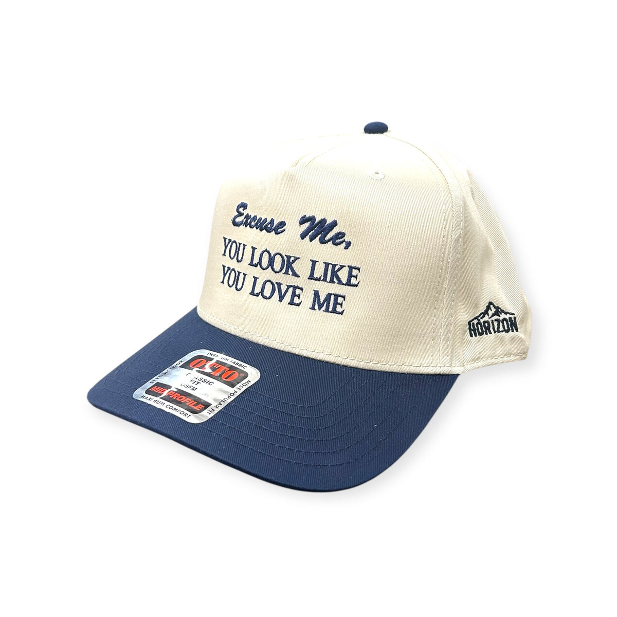 Angled view of Excuse Me, You Look Like You Love Me embroidered cap by Horizon Hat Co. in natural/navy showing the bill and side panels