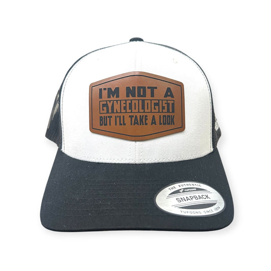 Front view of Not A Gynecologist patch hat by Horizon Hat Co. in white/black showing adult-humor i'm not a gynecologist, but i'll take a look patch