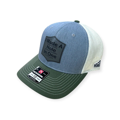 Angled view of Hole In One patch hat by Horizon Hat Co. in gray/birch/olive showing the curved bill and side panels