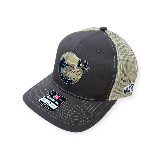 Angled view of Duck Hunt patch hat by Horizon Hat Co. in brown/khaki showing the curved bill and side panels