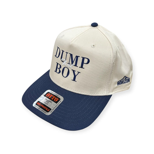 Angled view of Dump That Boy embroidered cap by Horizon Hat Co. in natural/navy showing the bill and side panels