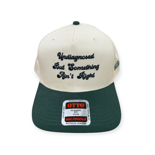 Natural and green Otto cap with Undiagnosed, But Something Ain't Right embroidery, front view