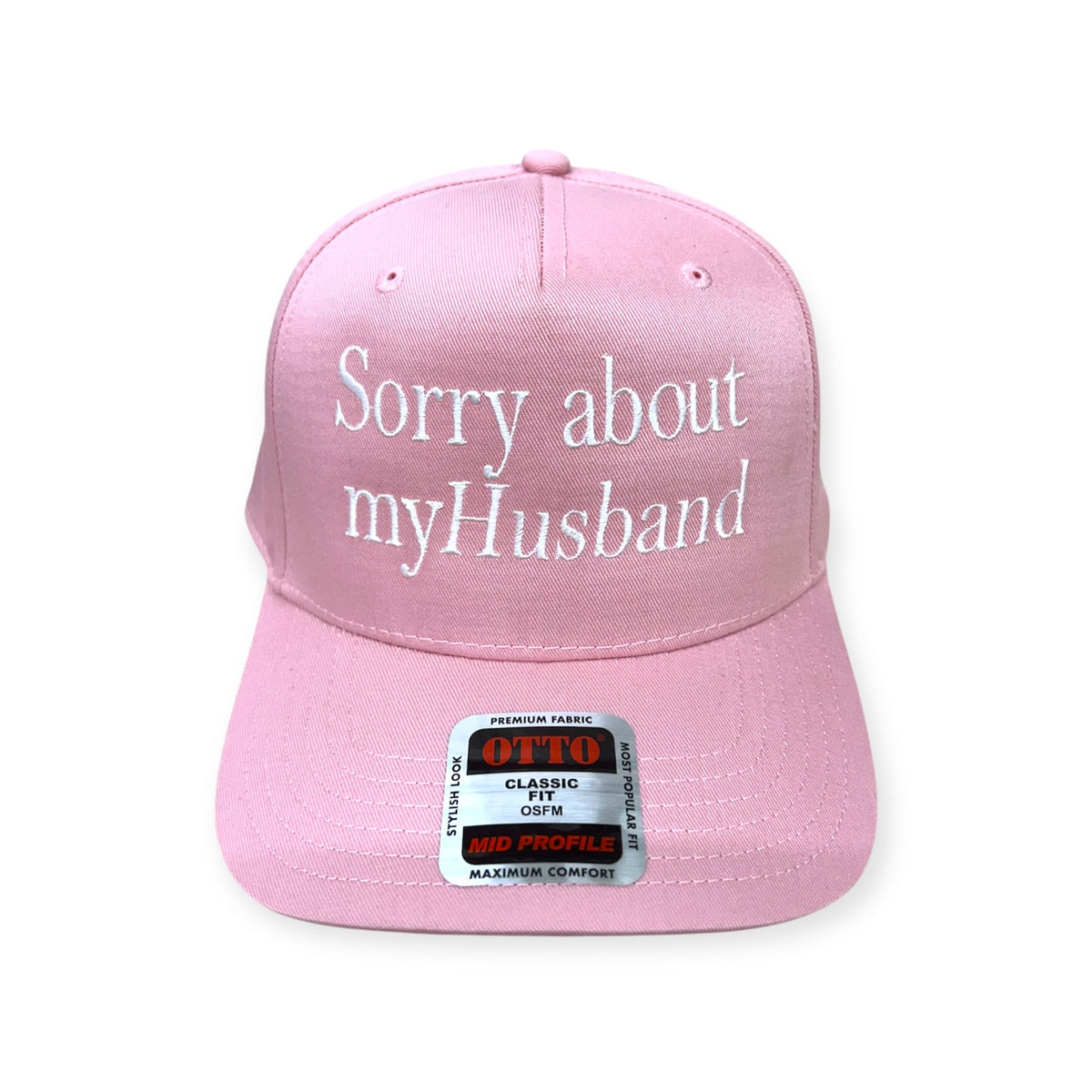 Front view of Sorry About My Husband embroidered cap by Horizon Hat Co. in pink showing white sorry about my husband front embroidery