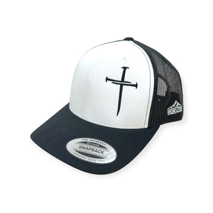 Angled view of Nailed to the Cross embroidered cap by Horizon Hat Co. in white/black showing the curved bill and side panels