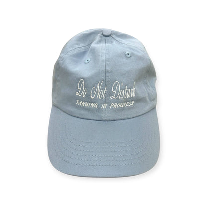 Front view of Do Not Disturb, Tanning in Progress embroidered cap by Horizon Hat Co. in blue showing do not disturb, tanning in progress front embroidery