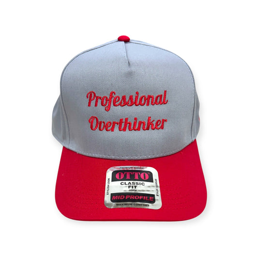Front view of Professional Overthinker embroidered cap by Horizon Hat Co. in gray/red showing professional overthinker script embroidery