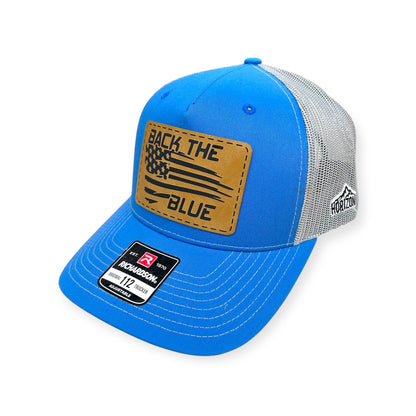 Angled view of Back the Blue patch hat by Horizon Hat Co. in blue/gray showing the curved bill and side panels
