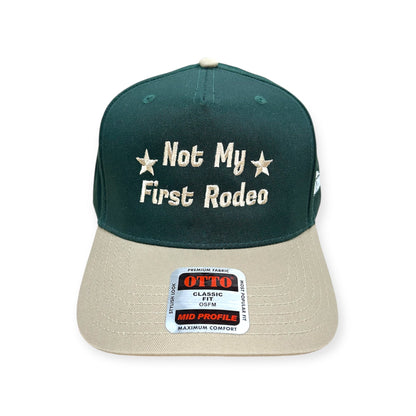 Front view of Not My First Rodeo embroidered cap by Horizon Hat Co. in green/natural showing not my first rodeo embroidery with stars