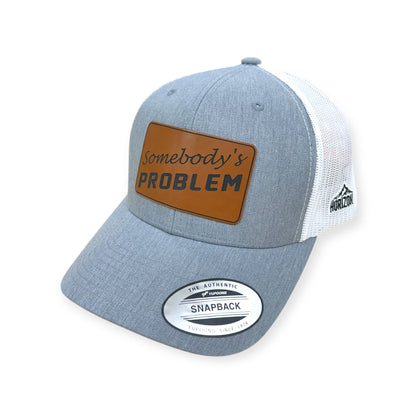 Angled view of Somebody's Problem patch hat by Horizon Hat Co. in heather gray/white showing the bill and side panels