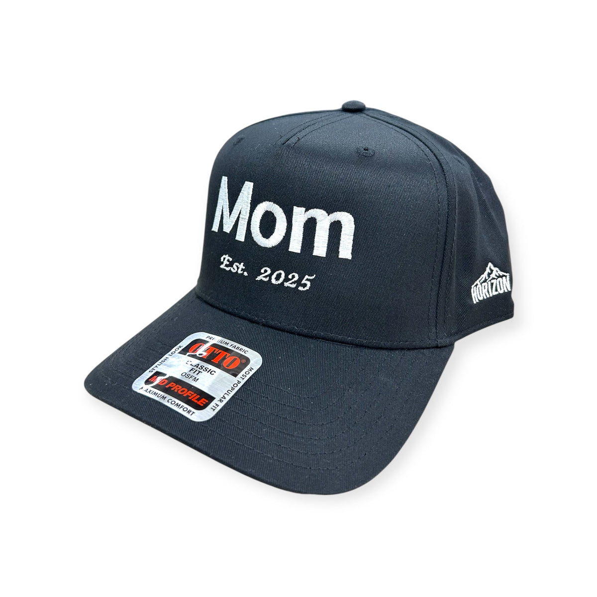 Angled view of Mom EST. 2025 embroidered cap by Horizon Hat Co. in navy/white lettering showing the bill and side panels