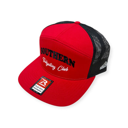 Angled view of Southern Tailgating Club embroidered cap by Horizon Hat Co. in red/black showing the bill and side panels