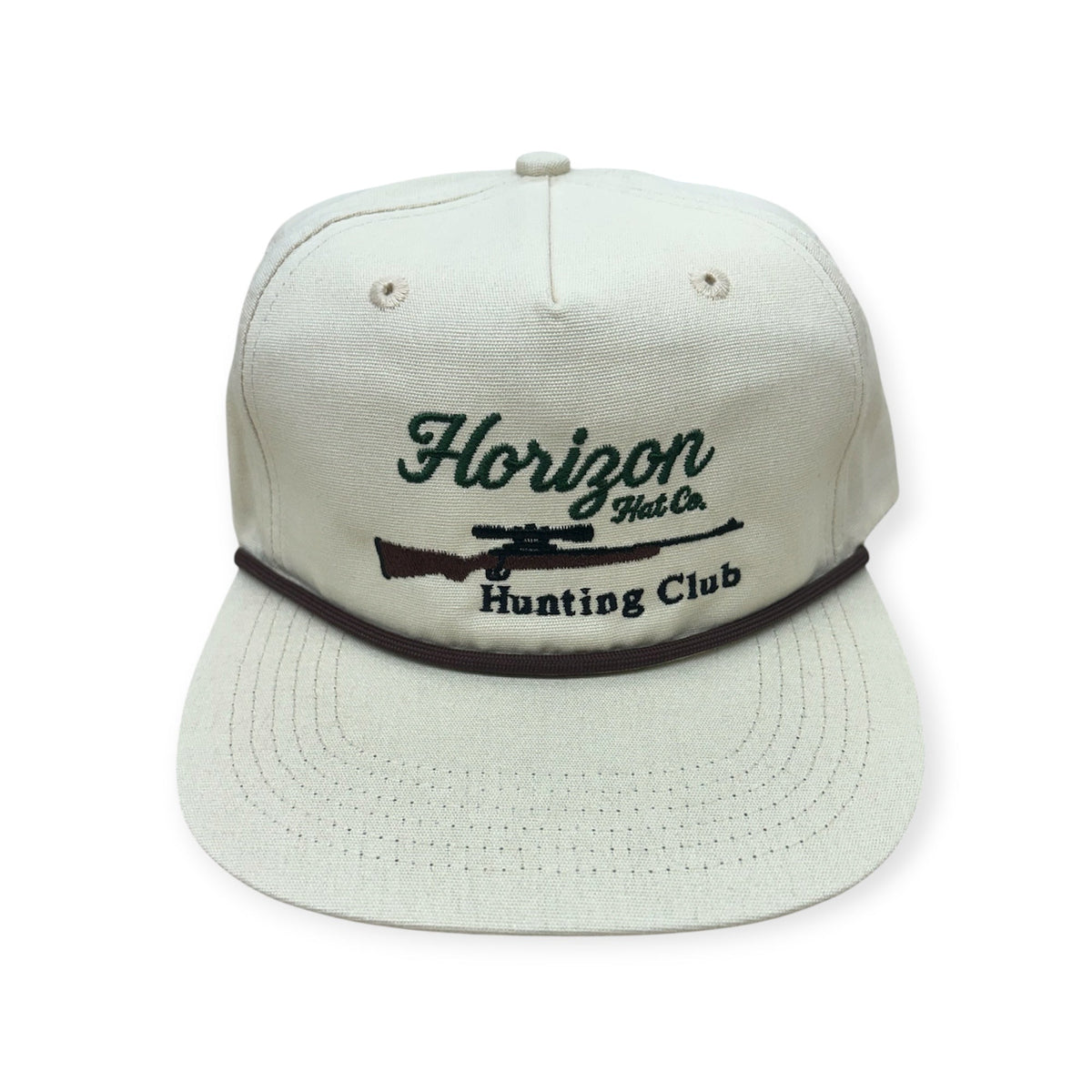 Front view of Horizon Hunting Club embroidered cap by Horizon Hat Co. in cream showing horizon hunting club lettering and rifle embroidery