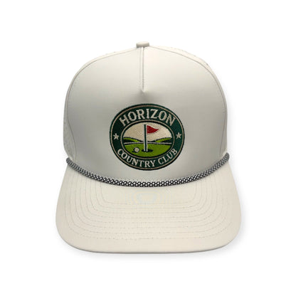 Front view of Horizon Country Club patch hat by Horizon Hat Co. in off white showing round horizon country club golf design and rope detail