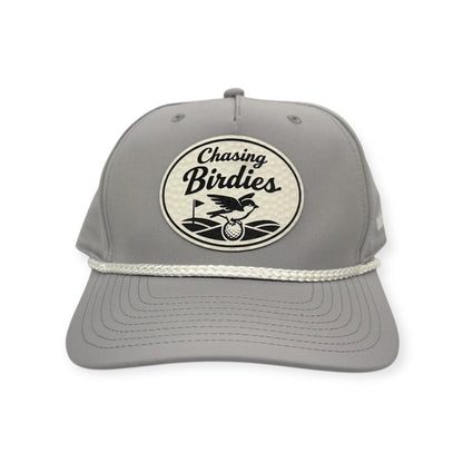 Front view of Chasing Birdies patch hat by Horizon Hat Co. in light gray/white showing birdie-themed golf patch with a golf-ball-textured surface