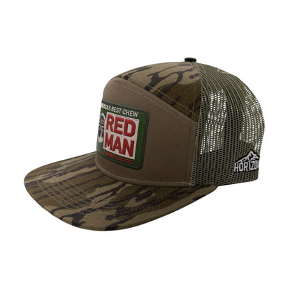 Angled view of RED MAN patch hat by Horizon Hat Co. in bottomland 7 panel trucker showing the bill and side panels