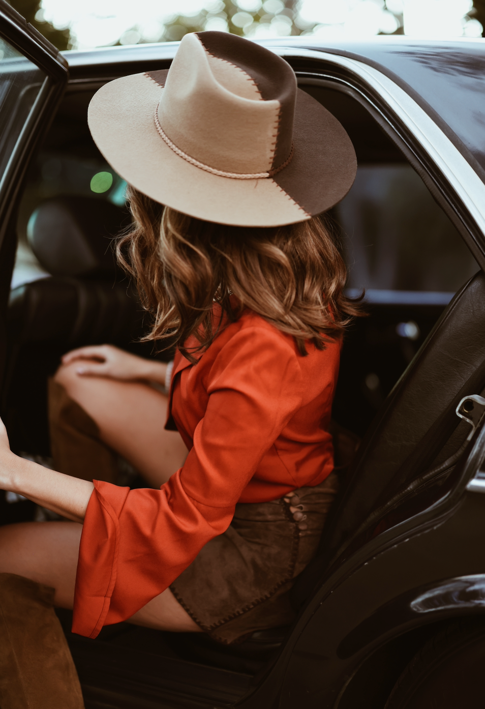 ASN Hats Cruel Intentions - Brown & Tan brown and tan fedora hat, worn beside a car with a red blouse
